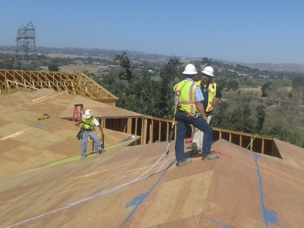 Construction workers working on a roof.