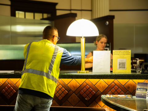 Image of staff assisting a man at the front counter in City Hall.